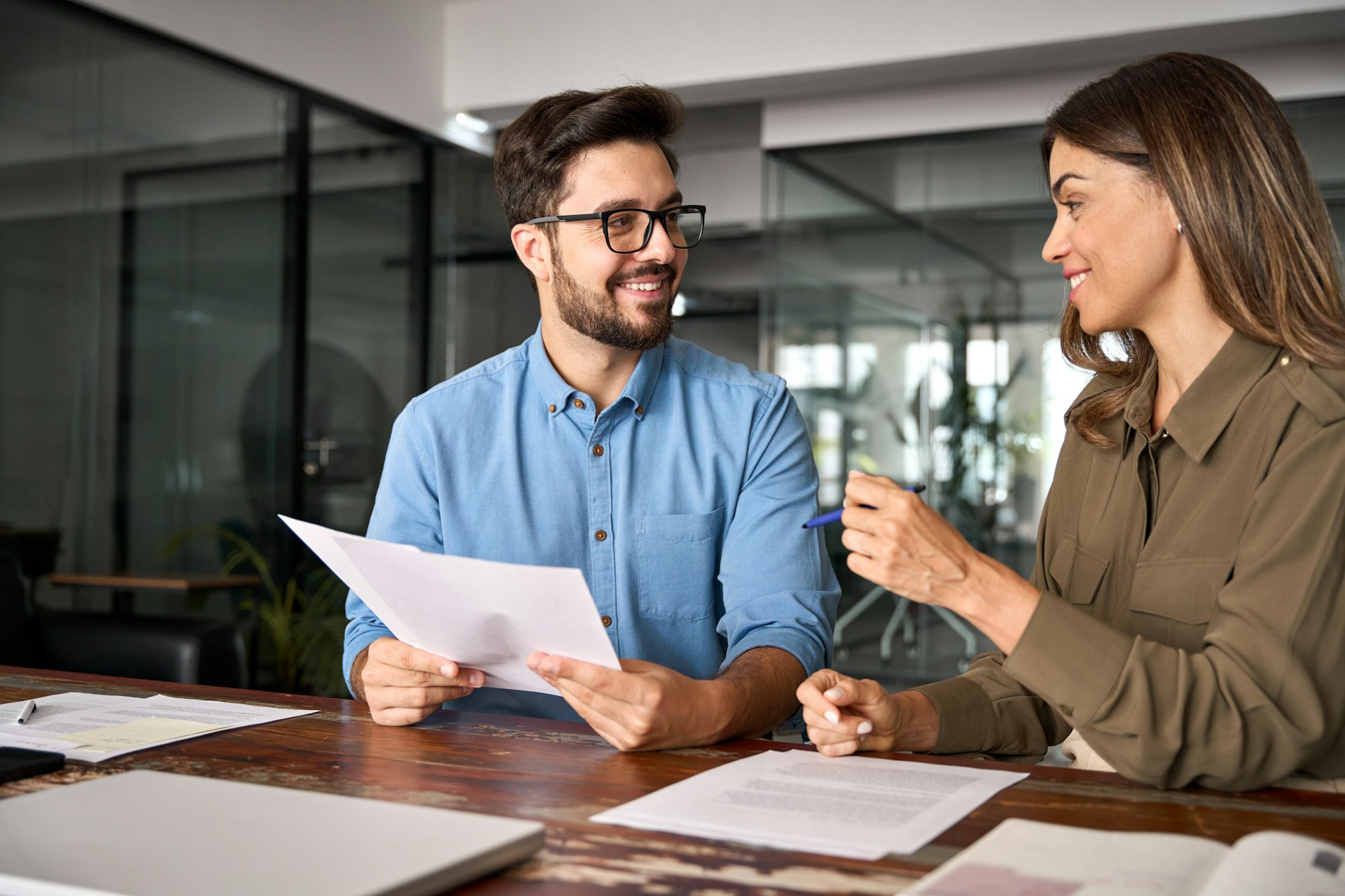Female advisor attorney lawyer consulting client investor at meeting.